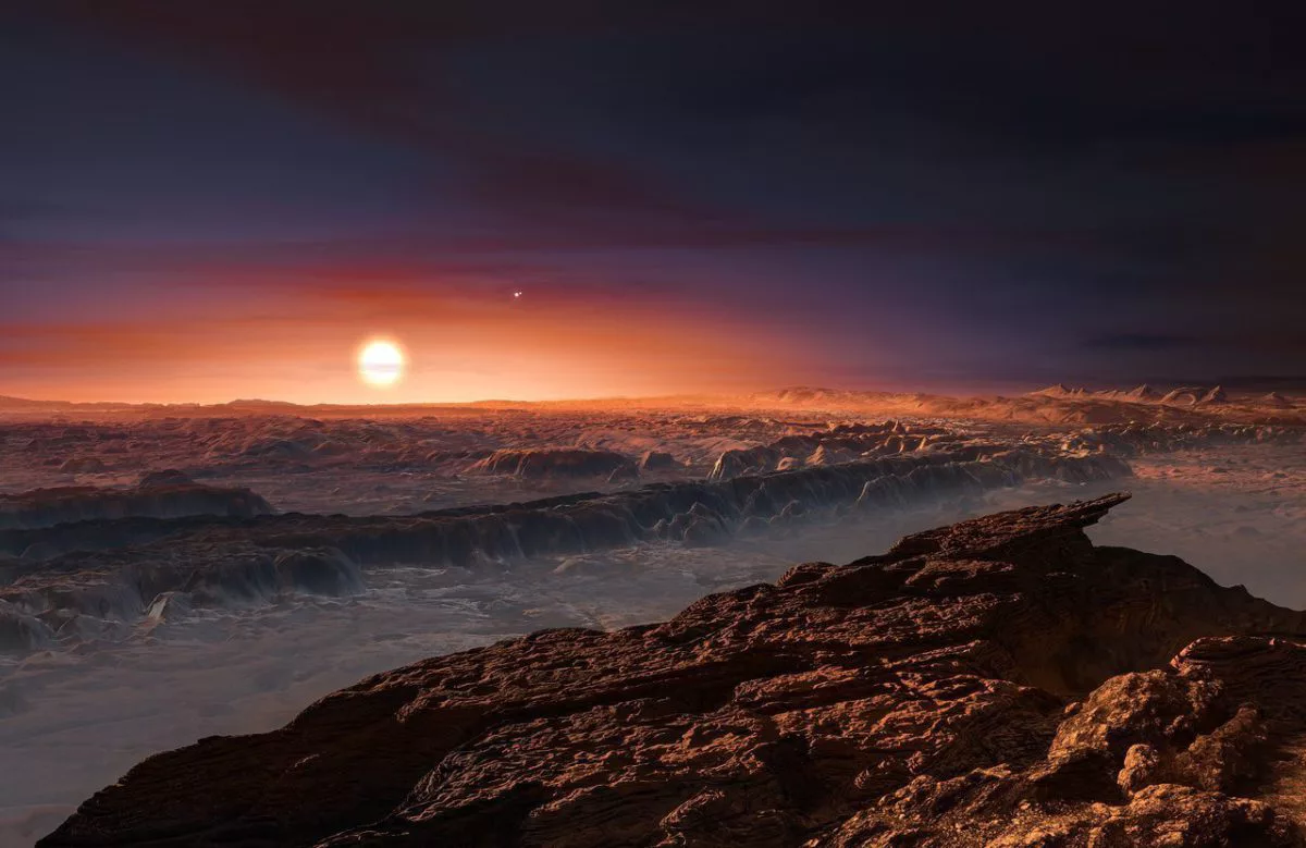 Exoplaneta Proxima B. Esta impressão artística mostra a superfície do exoplaneta Proxima b, orbitando a estrela anã vermelha Proxima Centauri — a estrela mais próxima da Terra. O planeta é semelhante em tamanho à Terra e está localizado na zona habitável de sua estrela, a região nem muito quente nem muito fria, onde as temperaturas são adequadas para a existência de água líquida na superfície.